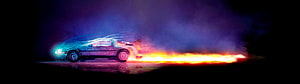 Sports car drifting with a blazing fire trail and neon light streaks on a dark stage HD wallpaper