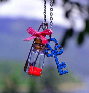 Handcrafted Beaded Key and Message in a Bottle Necklace with Pink Ribbon HD phone wallpaper