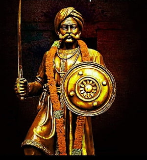 Golden Statue of Kempegowda Holding Sword and Shield with Marigold Garland HD phone wallpaper