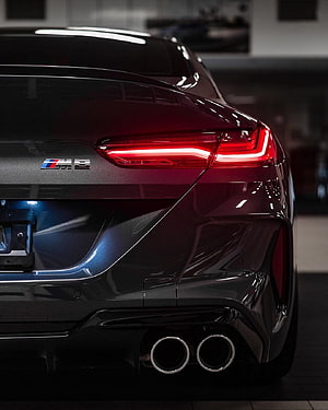 Rear View of a Dark Metallic BMW M8 with Dual Exhaust and LED Taillights HD phone wallpaper