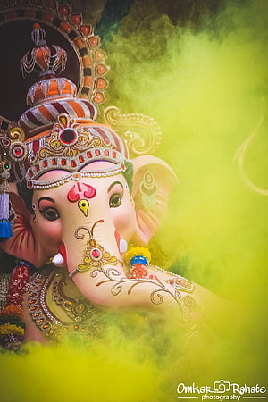 Lord Ganesha Portrait with Yellow Holi Colors and Intricate Jewelry HD phone wallpaper