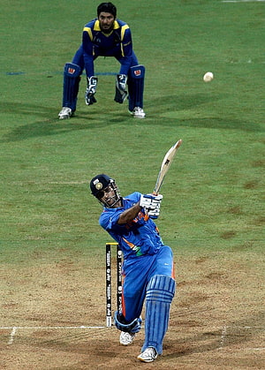 Indian cricketer playing a shot in blue jersey during a match HD phone wallpaper