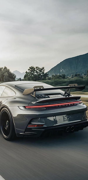 Rear View of a Dark Grey Porsche 911 GT3 with Large Rear Wing on a Mountain Road HD phone wallpaper