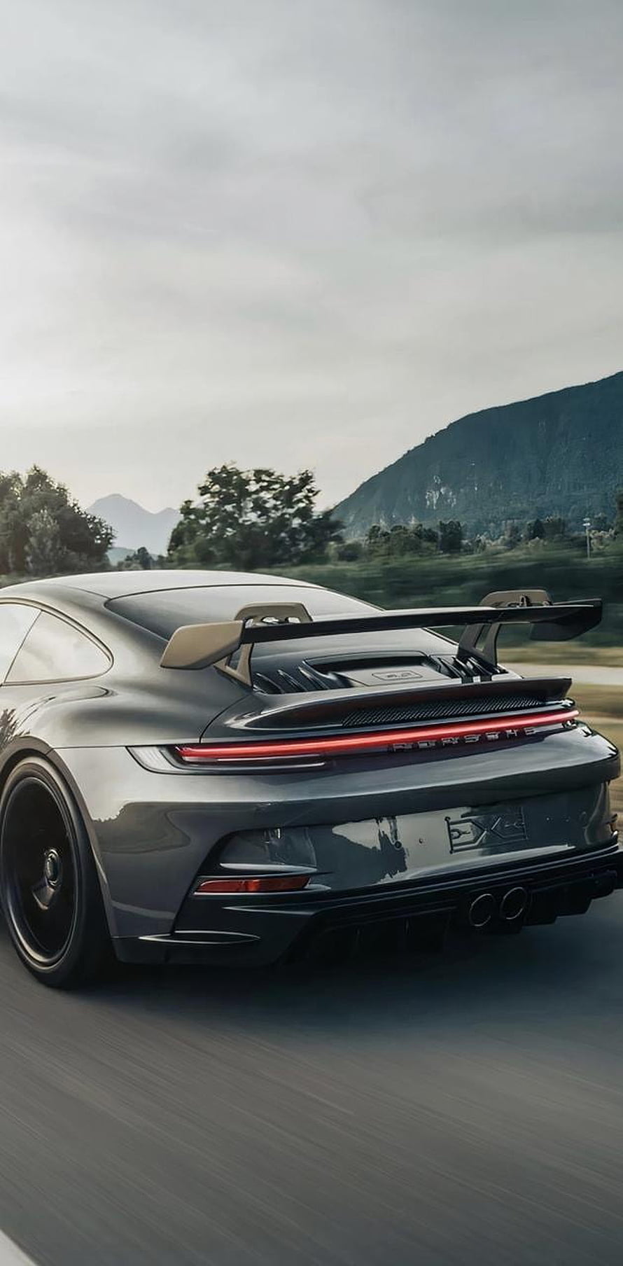 Rear View of a Dark Grey Porsche 911 GT3 with Large Rear Wing on a Mountain Road HD phone wallpaper