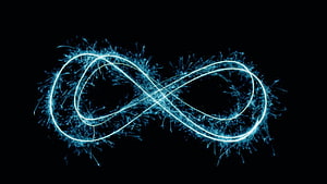 Glowing Blue Infinity Symbol with Electric Particle Effects on Black Background HD wallpaper