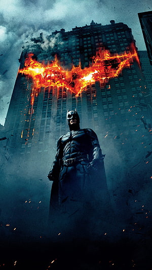 Batman stands before a burning building with a flaming bat symbol in a dark cinematic scene, Batman The Dark Knight Rises, the dark knight HD phone wallpaper