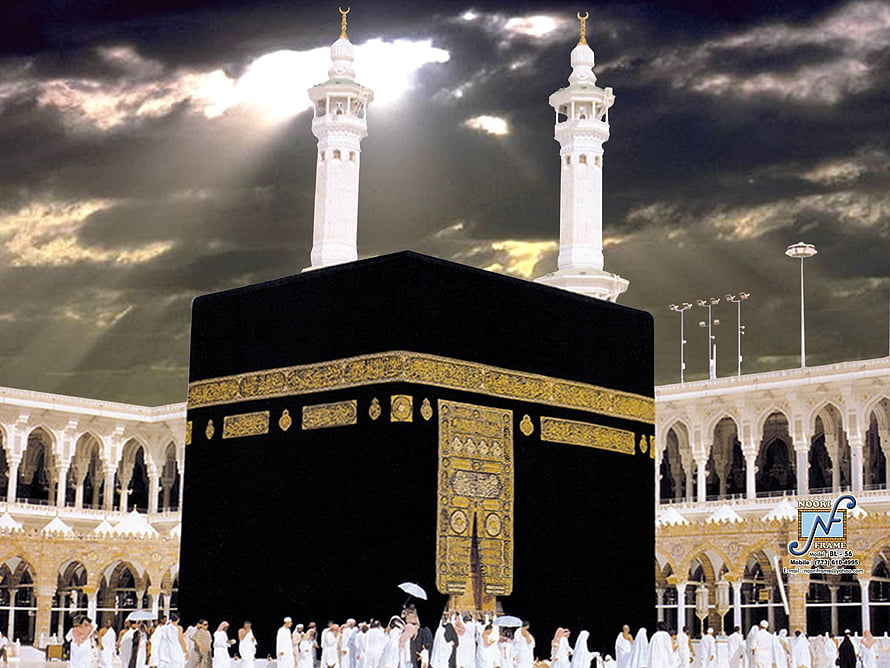 The Kaaba in Mecca with pilgrims and minarets under a dramatic cloudy sky HD wallpaper