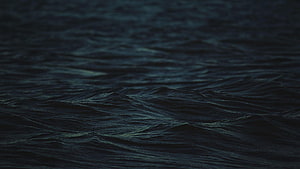 Dark Ocean Waves at Night with Deep Blue Tones and Subtle Surface Ripples HD wallpaper