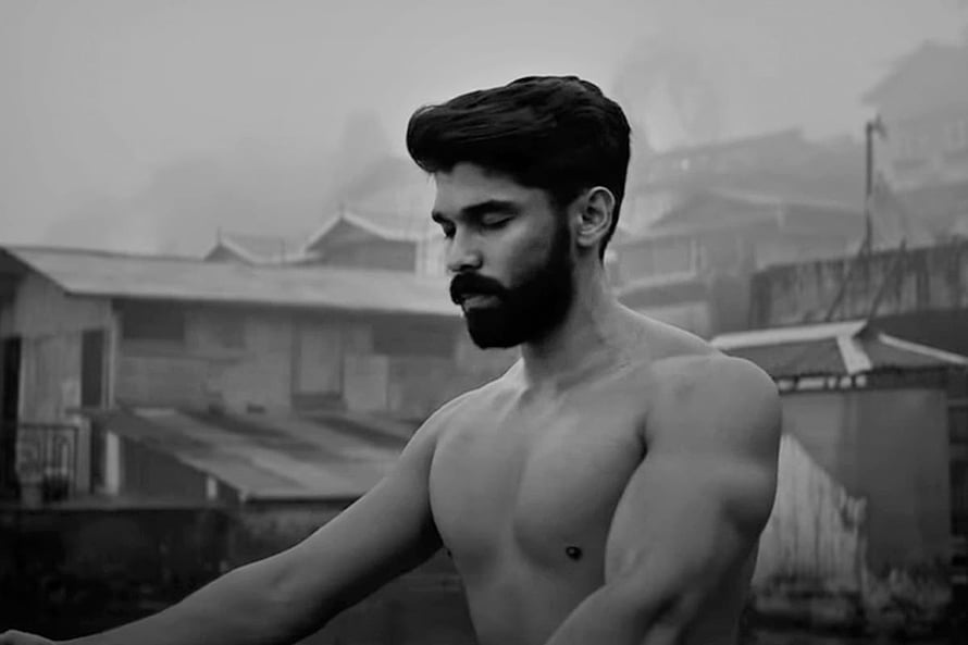Dhruv Vikram in a moody black and white portrait with a rugged urban backdrop HD wallpaper