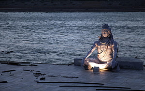 Illuminated Statue of Lord Shiva Meditating by the River Ganges at Night HD wallpaper