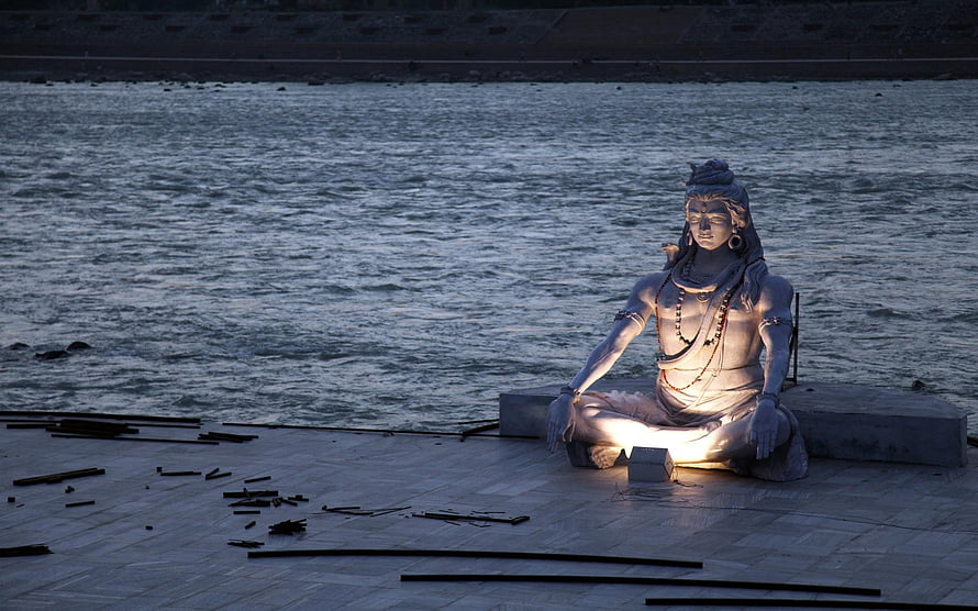 Illuminated Statue of Lord Shiva Meditating by the River Ganges at Night HD wallpaper