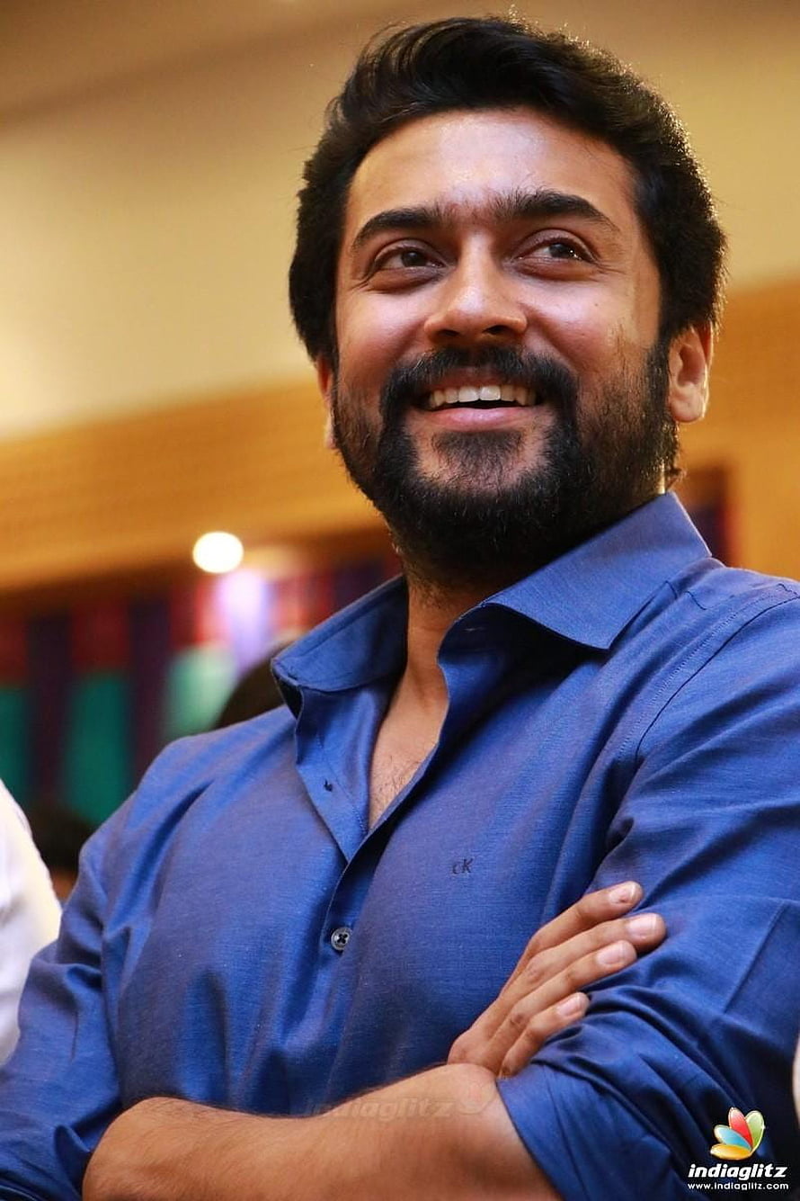 Suriya Smiling Portrait in Blue Shirt with Arms Crossed HD phone wallpaper