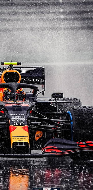 Red Bull Racing Formula 1 car speeding on a wet track in heavy rain HD phone wallpaper