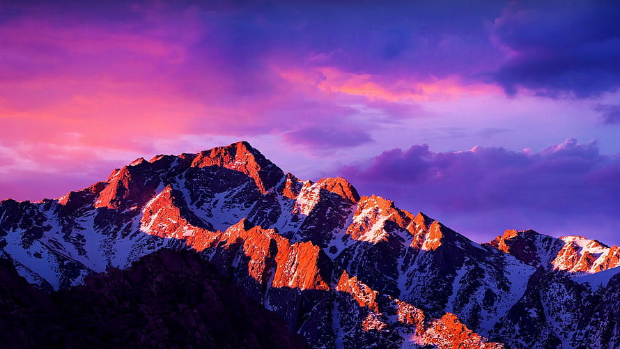 Snow-Capped Mountain Peaks Bathed in Vibrant Pink and Purple Sunset Light HD wallpaper
