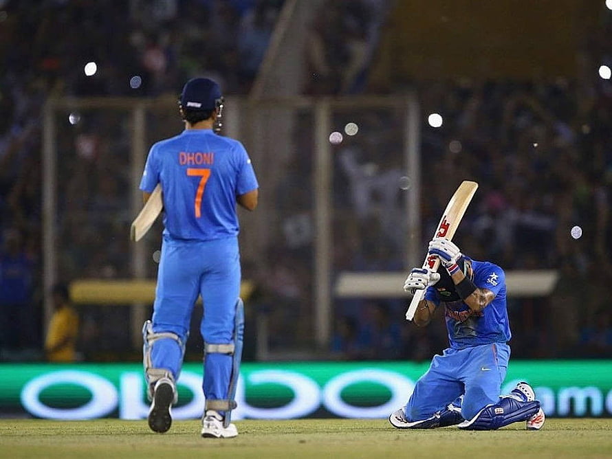 MS Dhoni and Virat Kohli Celebrating on the Cricket Field in Blue India Kits HD wallpaper