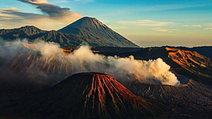 Breathtaking Aerial View of Mount Bromo Volcano with Rising Smoke and Mist in East Java HD wallpaper