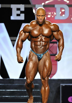 Phil Heath Bodybuilder Stage Pose With Defined Musculature and Oiled Skin HD phone wallpaper