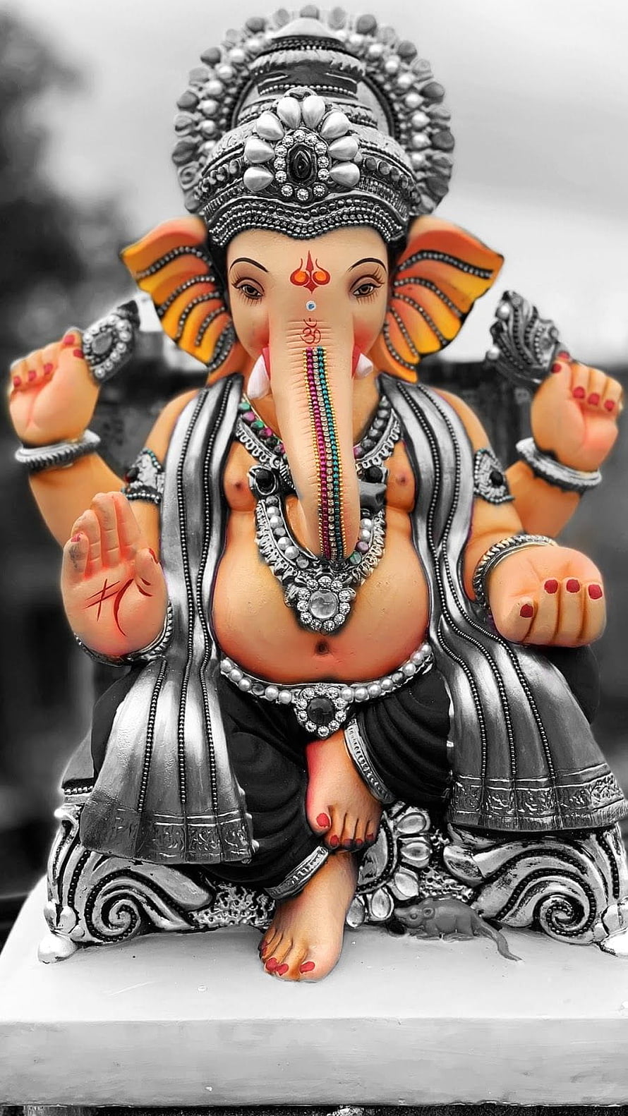 Ornate Silver Ganesha Statue with Colorful Accents and Intricate Jewelry Details HD phone wallpaper