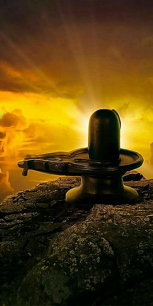 Shiva Lingam on Rocky Cliff with Golden Sunset Sky and Divine Light Rays HD phone wallpaper