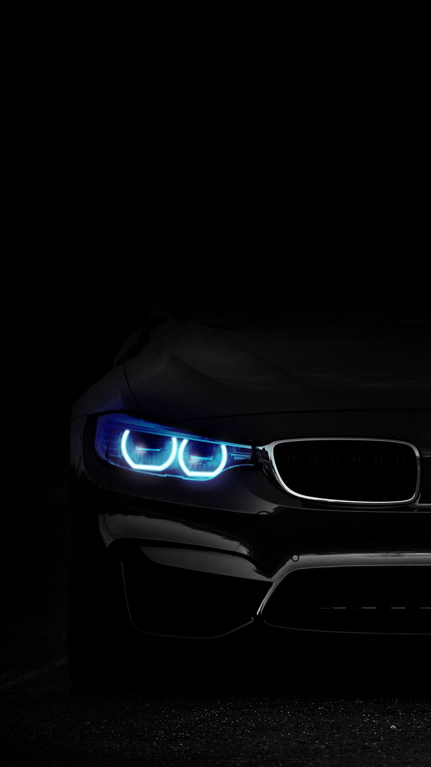 BMW M3 Front Headlight Close-Up with Blue Angel Eyes on Black Background HD phone wallpaper