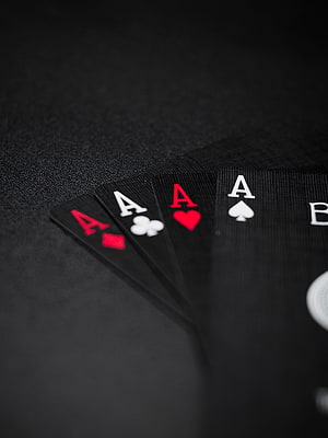 Four Aces of Playing Cards Fanned on a Dark Textured Surface HD phone wallpaper