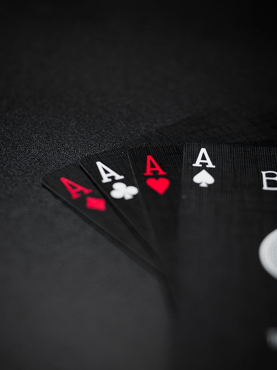 Four Aces of Playing Cards Fanned on a Dark Textured Surface HD phone wallpaper