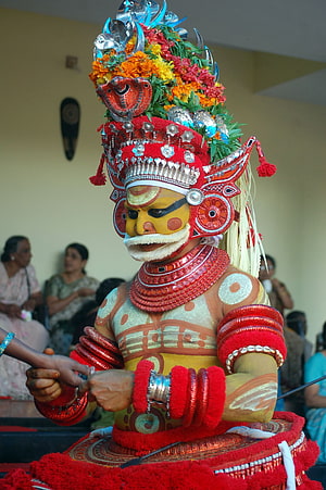 Traditional Yakshagana Performer in Elaborate Red Costume and Headdress HD phone wallpaper