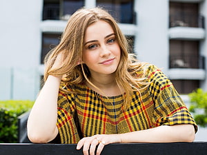 Josephine Langford in a yellow plaid top leaning on a railing outdoors HD wallpaper