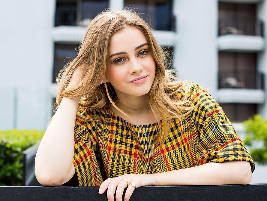 Josephine Langford in a yellow plaid top leaning on a railing outdoors HD wallpaper