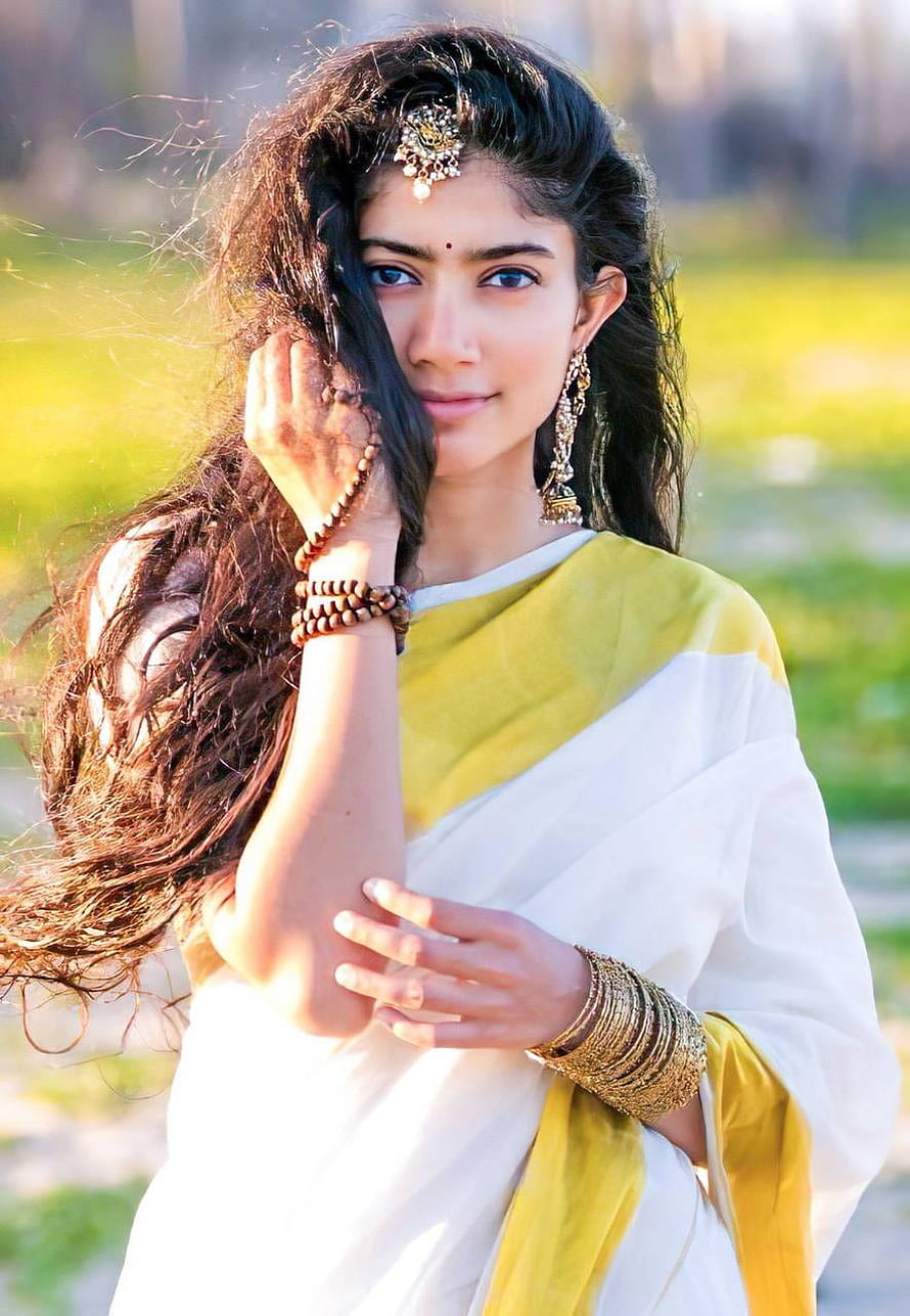 Portrait of a woman in a white and yellow saree with traditional jewelry and henna, Sai pallavi by invisiblesmilesss, sai pallavi saree HD phone wallpaper
