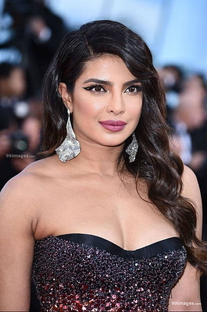 Priyanka Chopra in a Sparkling Strapless Gown with Statement Earrings at a Red Carpet Event HD phone wallpaper