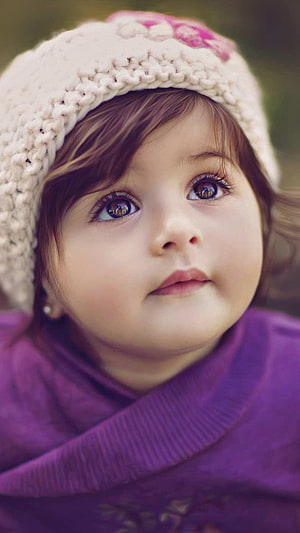 Portrait of a cute baby girl with big eyes wearing a white knitted hat and purple sweater HD phone wallpaper