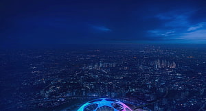 UEFA Champions League Ball Floating Over a Glowing City at Night HD wallpaper