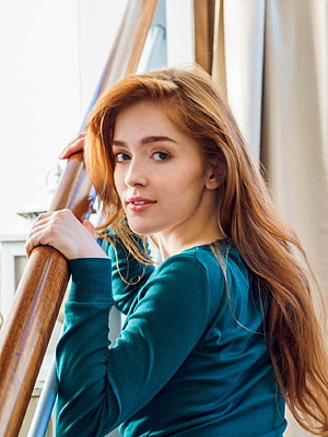 Jia Lissa Portrait in Teal Top Leaning on Wooden Staircase Railing HD phone wallpaper