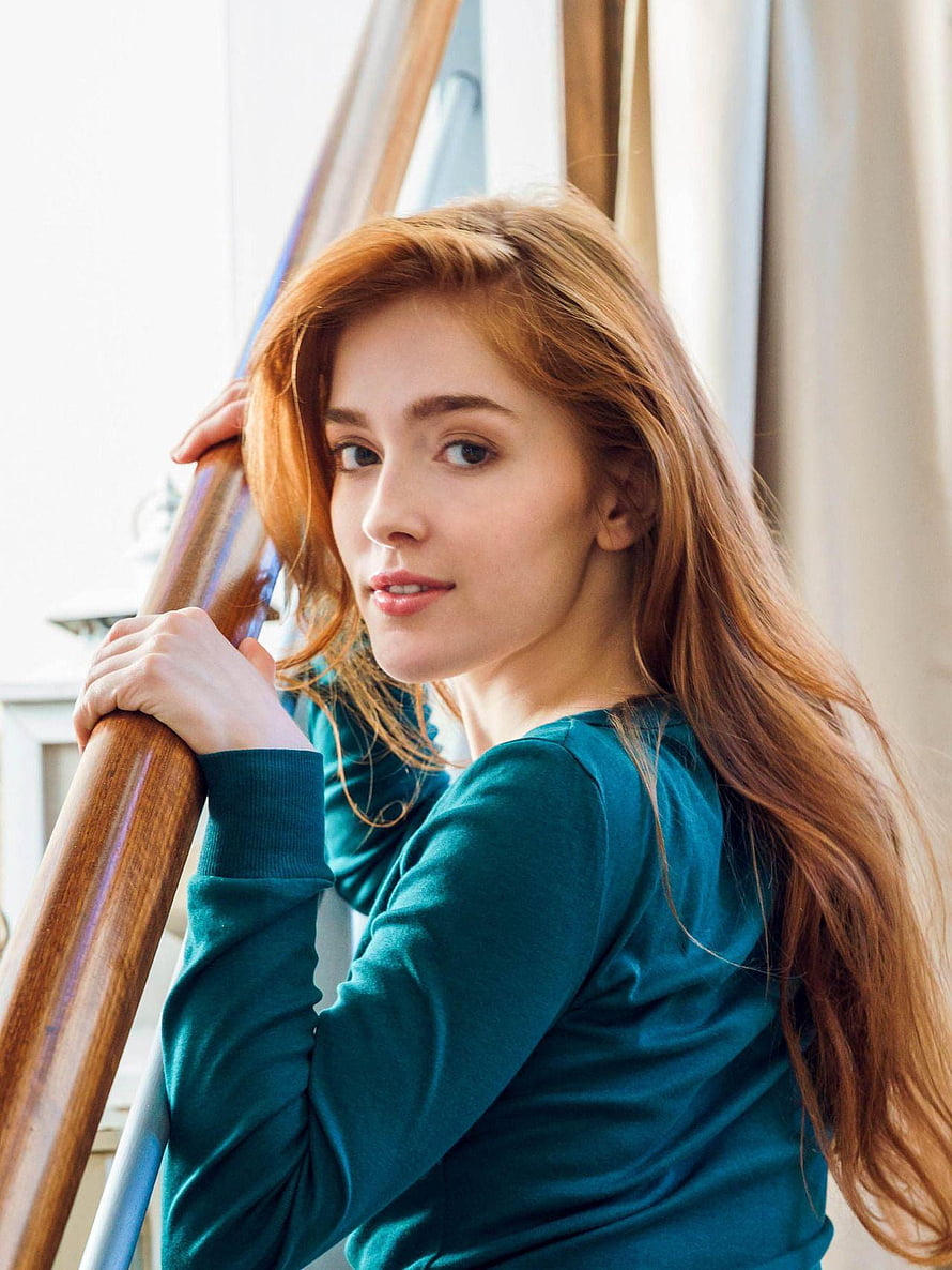 Jia Lissa Portrait in Teal Top Leaning on Wooden Staircase Railing HD phone wallpaper