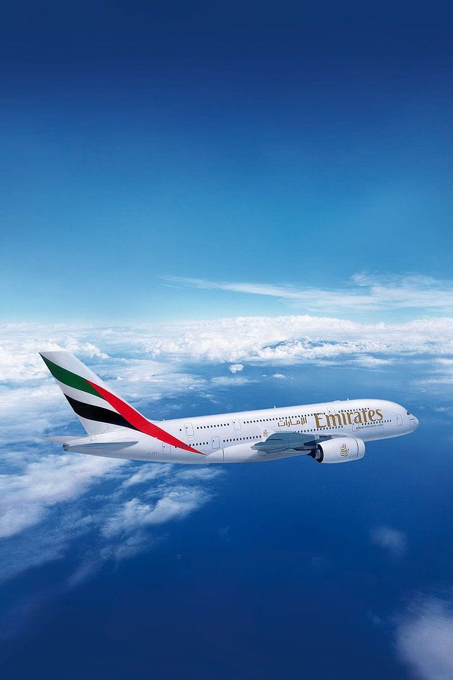 Emirates Airliner Cruising Above Clouds in Clear Blue Sky HD phone wallpaper