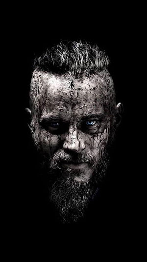 Ragnar Lothbrok Dark Portrait with Intense Blue Eyes and Weathered Beard HD phone wallpaper