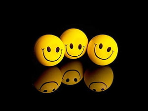 Three Yellow Smiley Face Balls on Black Background HD wallpaper
