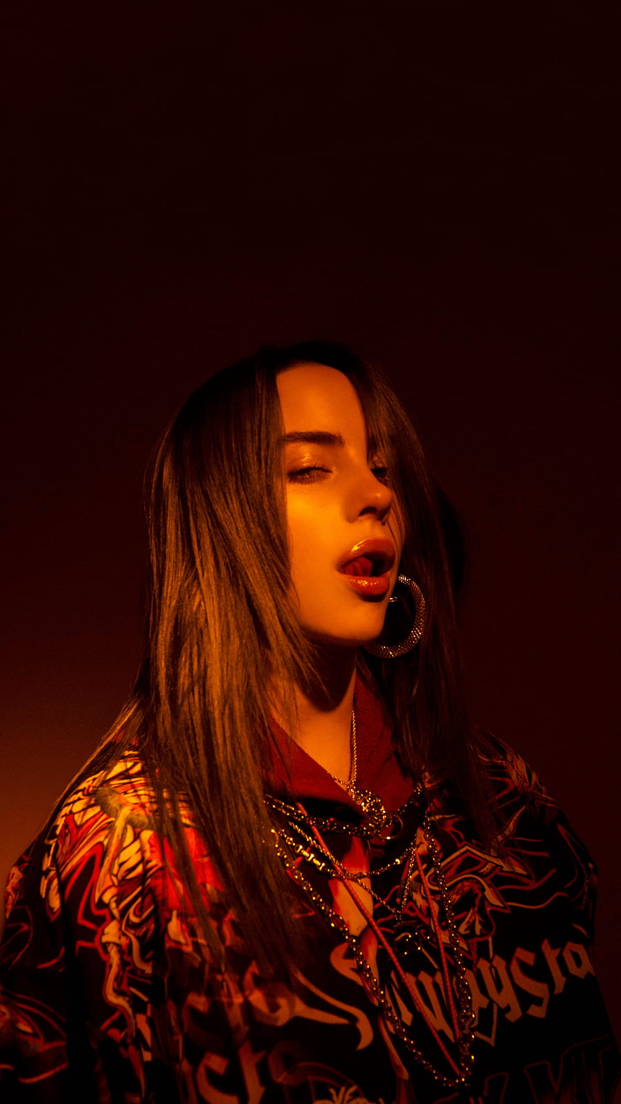 Billie Eilish in Dramatic Red Lighting Wearing Graphic Hoodie and Layered Jewelry HD phone wallpaper