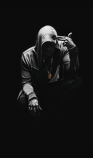 Mysterious hooded figure in dark shadows with gold chain and rings HD phone wallpaper