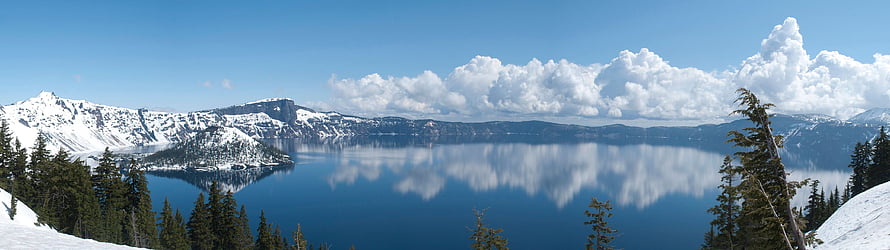 Panoramic View of Crater Lake in Winter with Snow-Capped Peaks and Mirror Reflections HD wallpaper