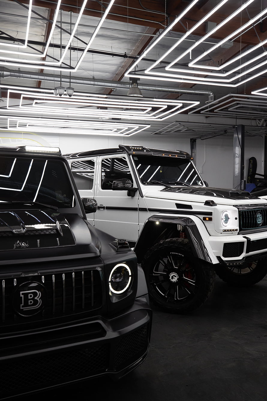 Brabus Modified Mercedes G-Class SUVs in Modern Garage with Neon Lights HD phone wallpaper