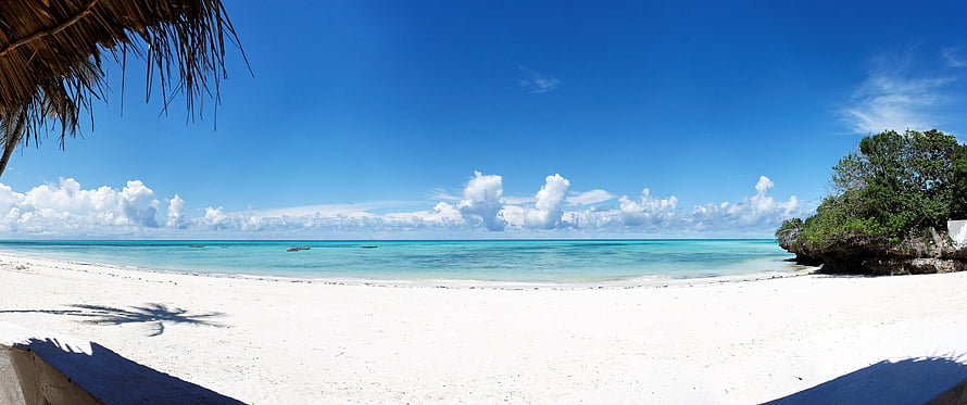 Panoramic View of Pristine White Sand Beach with Turquoise Ocean and Blue Sky HD wallpaper