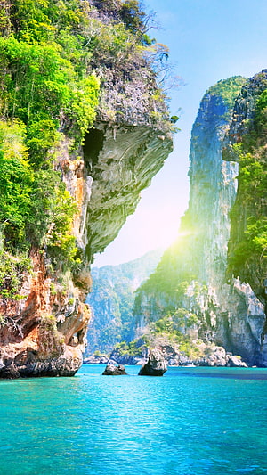 Stunning View of Turquoise Waters and Lush Green Cliffs in a Tropical Bay HD phone wallpaper