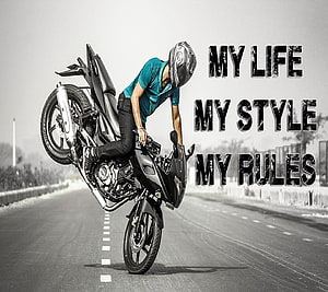 Motorcyclist Performing a Wheelie on an Empty Highway with Bold Attitude Text Overlay HD wallpaper