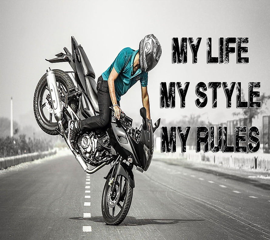 Motorcyclist Performing a Wheelie on an Empty Highway with Bold Attitude Text Overlay HD wallpaper