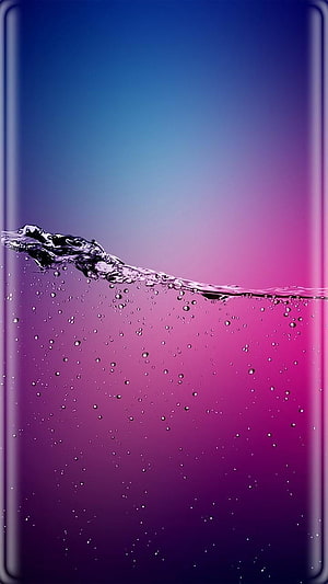 Vibrant Water Splash with Bubbles on Blue to Purple Gradient Background HD phone wallpaper