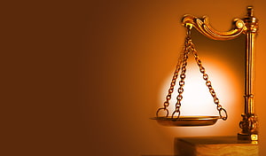 Golden Scales of Justice on a Warm Amber Background HD wallpaper