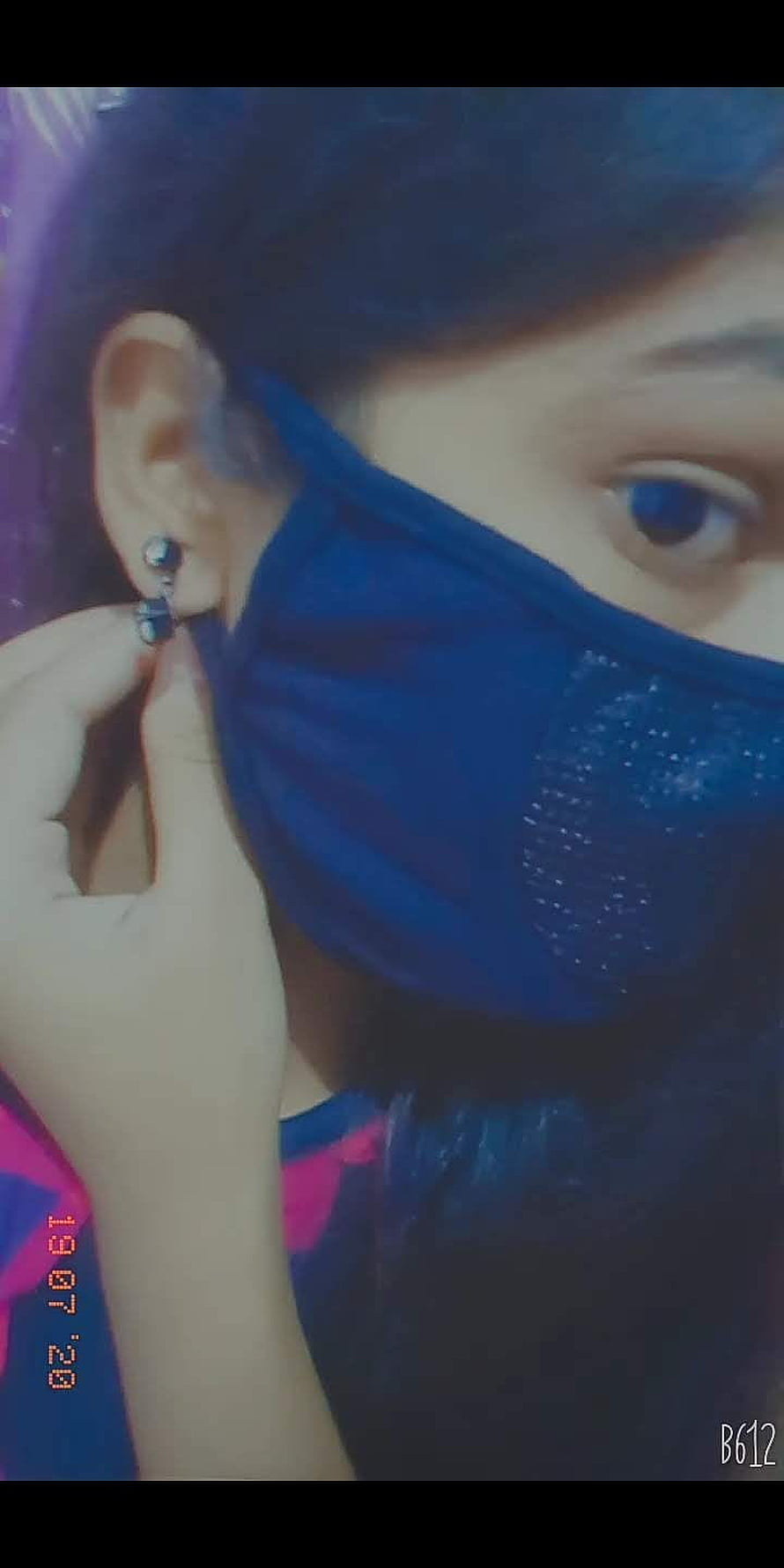 Close-up portrait of a person wearing a blue face mask and earring, vintage film aesthetic HD phone wallpaper