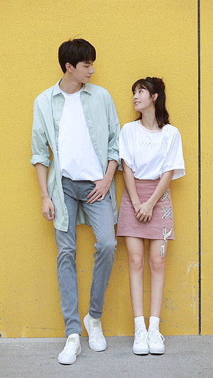 Lin Yi and Xing Fei in Casual Streetwear Against a Yellow Wall HD phone wallpaper